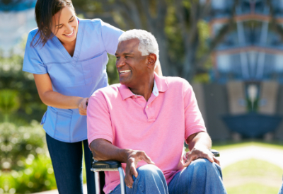 caregiver pushing senior man in wheelchair